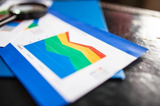 Close-up of a colorful business chart placed on a table with documents highlighting trends.