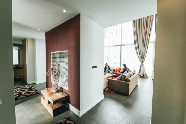 Spacious modern living room featuring large windows and contemporary furniture.