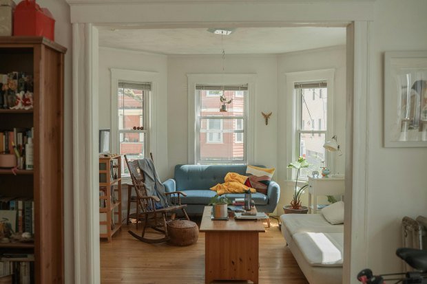 This cozy living room showcases vibrant decor, natural light, and comfortable seating.